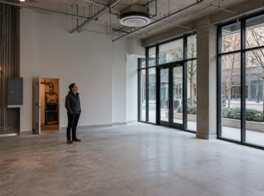 Prospective tenant inspects the systems and constraints of an unfurnished commercial space
